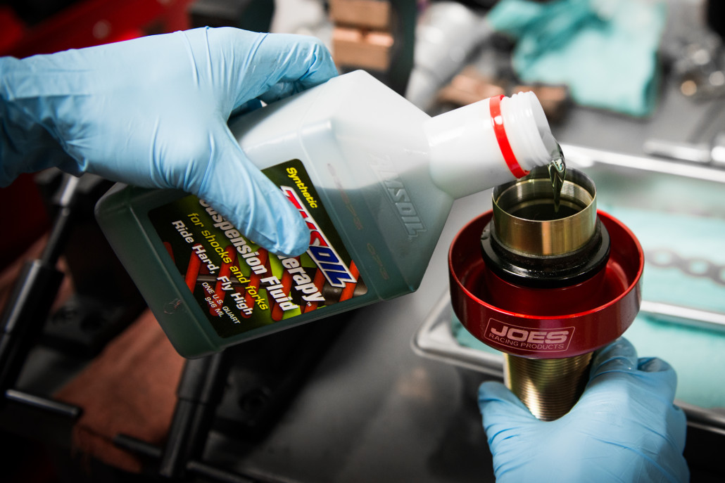 Stance dampener being filled with Amsoil fluid